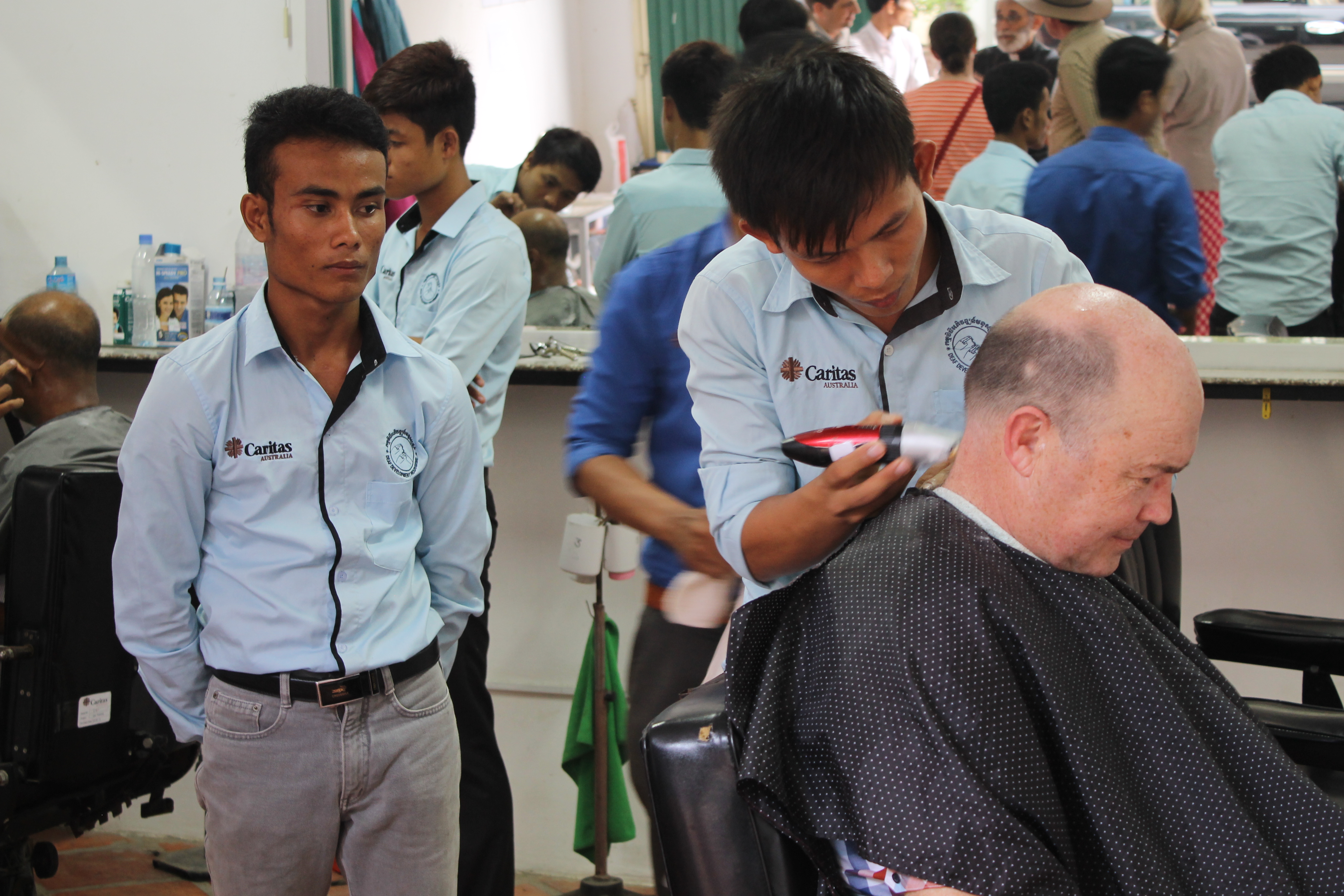 Chris getting his haircut by our up-and-coming barbers