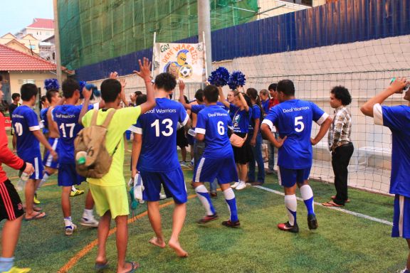 The Deaf Warriors exit the field to cheering fans despite their defeat