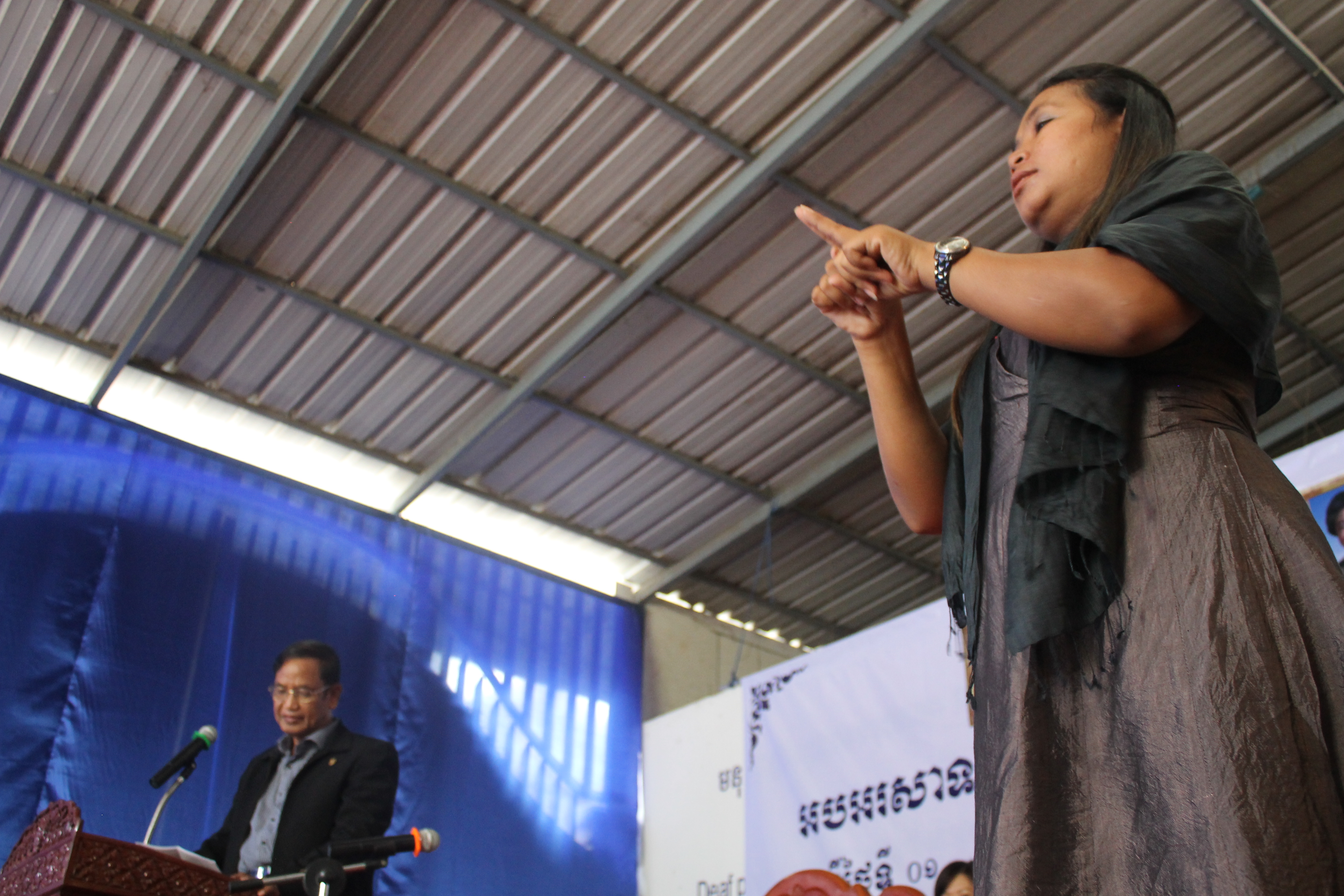  Minister H.E. Sem Sokha, Secretary of State of Social Affairs, Veterans, and Youth Rehabilitation delivering his speech while Vichet, DDP Project Manager, interprets. 