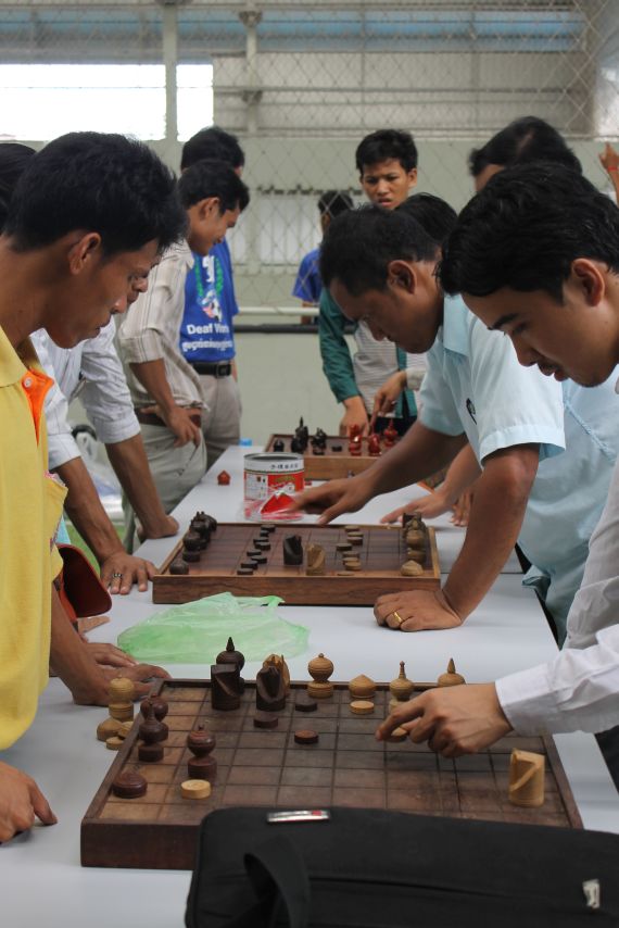Deaf community members and DDP staff members playing chess