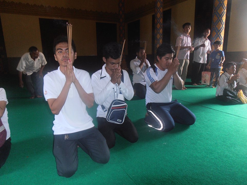 Three of the participants making an offering