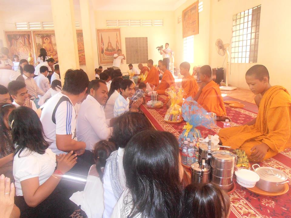 Making an offering of food to the monks and receiving a blessing in return