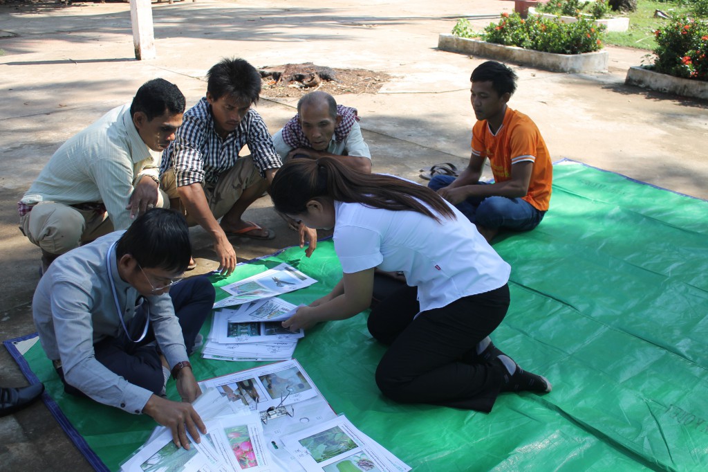 After arriving, the teachers pull out all the appropriate pictures for the day's lesson.  While one deaf student looks on, this group of hearing men are fascinated by the idea of a language where their are hand gestures for different things they encounter every day.