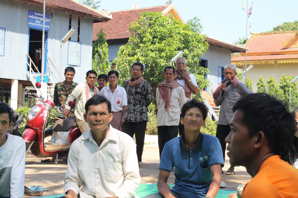 These men who were gathered playing chess at the Wat are also interested to see what it happening - for many, the idea of deaf people being able to communicate is completely foreign to them