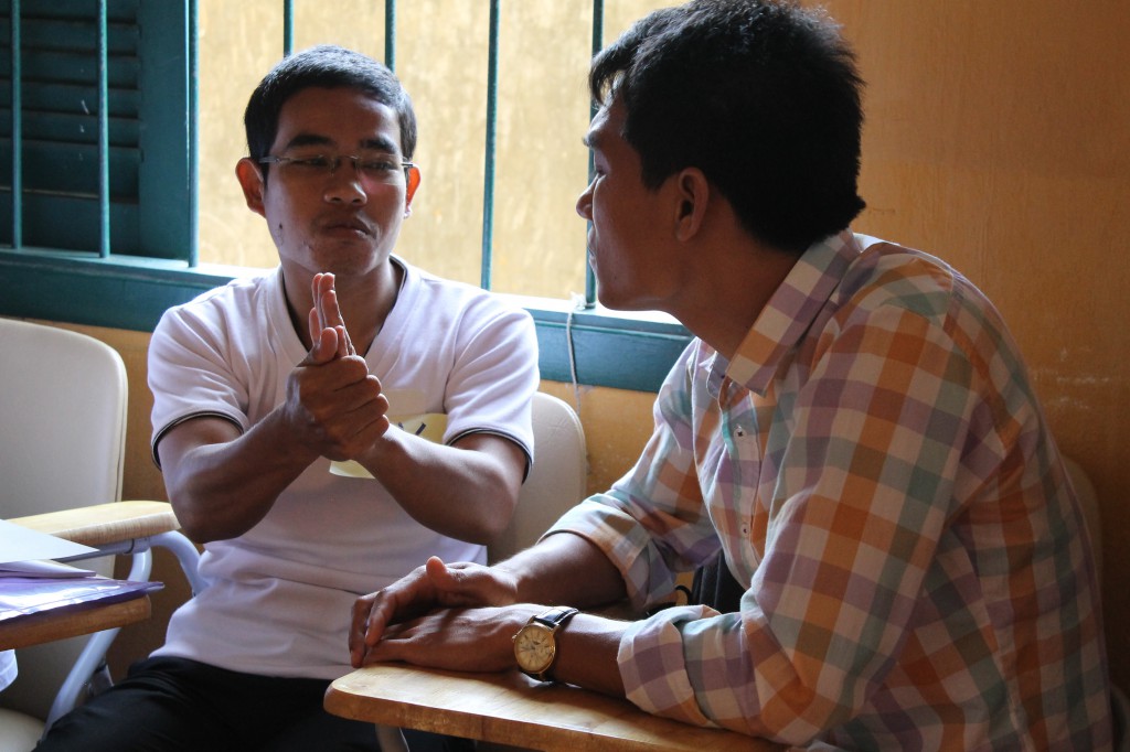 Another pair discussing the importance of interpreters being skilled in sign language