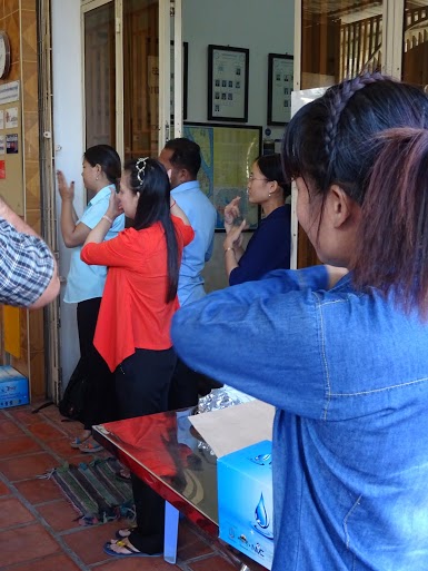 Phnom Penh staff members signing the national anthem of Cambodia