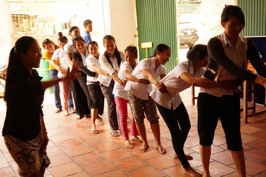 In this traditional Khmer game, men and women line up for a tug of war. DDP teachers and staff are cheering on the students.