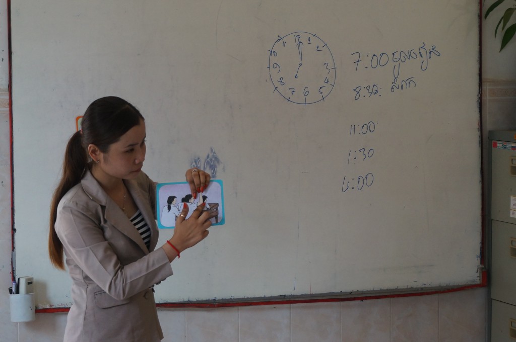 One of the teachers from Kampot is showing her colleagues the tools she uses in her classroom.